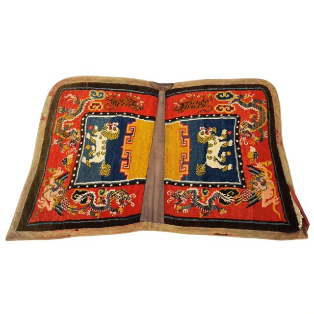 Our July #ArtifactOfTheMonth is a Tibetan saddle rug. This type of saddle rug was used for cushioning between the horse’s back and the saddle. A second smaller rug would have been placed on top of the saddle for the comfort of the rider. Because Tibetan saddles were often made of wood, these rugs made riding more comfortable for both the horse and the rider. Many under-saddle rugs are made of two woven pieces joined together, as this one is. The shape of this rug with a pair of pointed corners is referred to as a butterfly design.
Known for their rich colors, unique decorations, and exquisite craftsmanship, Tibetan rugs can be classified as either religious or utilitarian. Utilitarian rugs such as saddle rugs can also feature imagery that expresses people’s beliefs. More detailed and intricate patterns indicate the owner’s higher socioeconomic status.

The main decorations found on this saddle rug are dangerous creatures: dragons, tigers, lions, and bird-like Garudas fighting with snake-like Nagas. Dragon imagery is common on saddle rugs because it represents wealth. Merchants may choose this kind of rug to win the dragon’s favor, hoping for good fortune in their business.

The humanoid figures at the edge of the saddle rug are the Garuda in anthropomorphic form. Garuda is the “Lord of Birds” in Hindu Buddhist tradition, but it sometimes has a more sinister characterization in Tibetan Buddhism. The Naga are a type of intelligent and evil serpents; here, they are being devoured by the Garudas. Thus, the appearance of the Garuda often represents protection.

The two snow lions in the center of the rug are celestial animals that indicate power and fearlessness. Tigers are considered to have the extraordinary power to cast out demons and control evil. The combination of the dragons, Garudas, snow lions, and tigers on the saddle conveys hope for being safe during transportation and having good fortune in business.

Research and writing for this post were provided by Michelle Ye ('25).

#Tibet #saddlerug #tibetanrugs #rug #textile #lammuseum #wakethearts